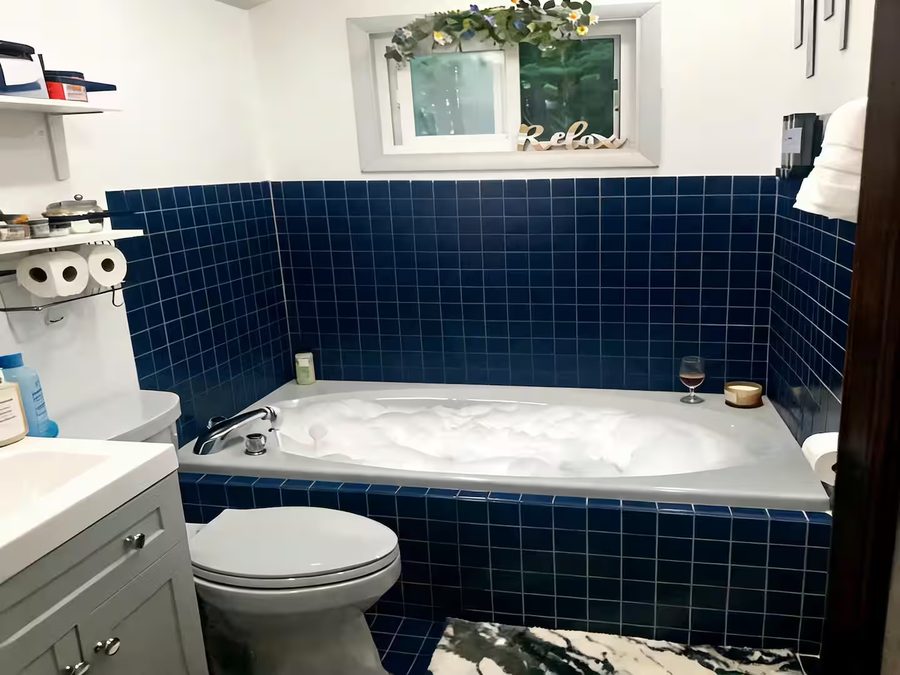 Private jacuzzi tub surrounded by deep blue tile